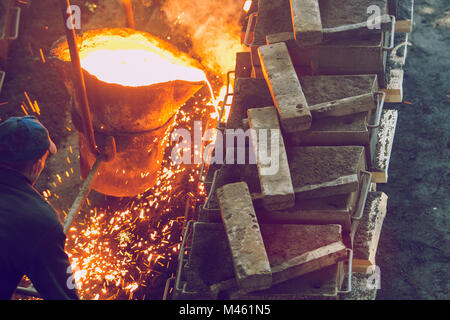 Cesis, Latvia, Metal foundry, workers pour metal, factory in city Cesis 2011. Stock Photo