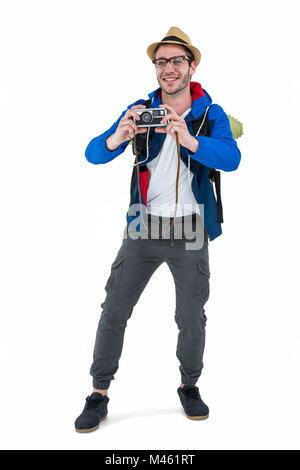 Backpacker hipster taking pictures with a retro camera Stock Photo - Alamy