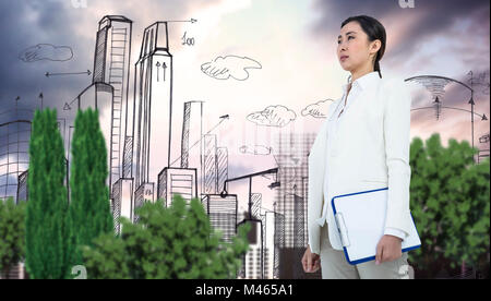 Composite image of smiling businesswoman holding clipboard Stock Photo
