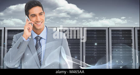 Composite image of businessman using mobile phone with colleagues behind Stock Photo