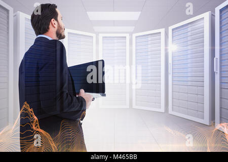 Composite image of businessman in suit holding laptop Stock Photo