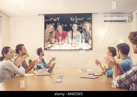 Composite image of college students doing homework in library Stock Photo