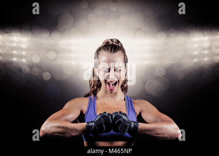 Composite image of aggressive female boxer flexing muscles Stock Photo