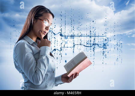 Composite image of concentrated businesswoman reading book Stock Photo