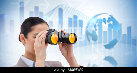 Composite image of brunette businesswoman looking through binoculars Stock Photo