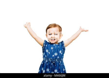 Excited little girl with arms outstretched up with a victorious smile Stock Photo