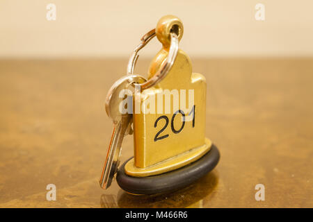 Hotel Room Key lying on Bed with keyring Stock Photo
