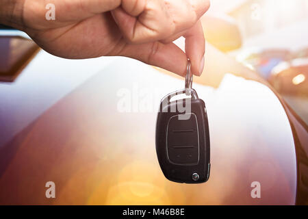 Close-up Of A Person's Hand Holding Car Key Stock Photo