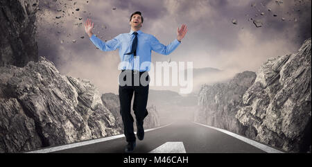 Composite image of happy businessman running with hands up Stock Photo