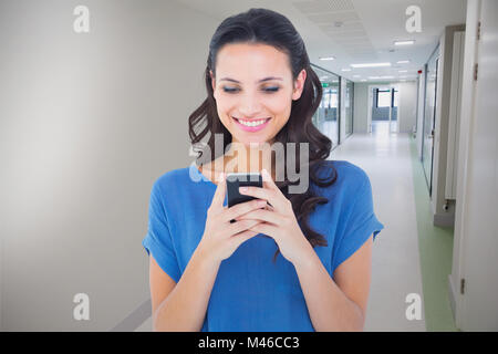 Composite image of pretty brunette sending a text Stock Photo