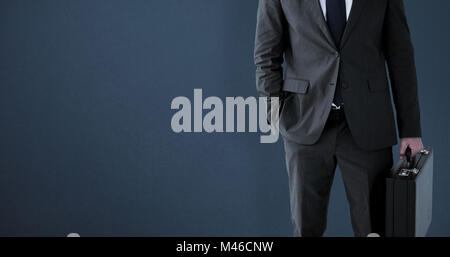 Composite image of businessman standing with his briefcase Stock Photo