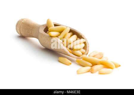 Healthy pine nuts in wooden scoop isolated on white background. Stock Photo