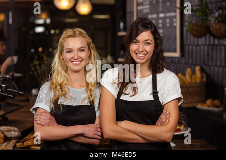 Pretty waitresses posing in front of the counter Stock Photo