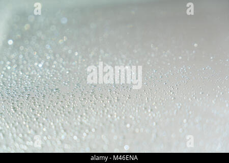 Close up of raindrops on window with sunlight. Generic background. Stock Photo