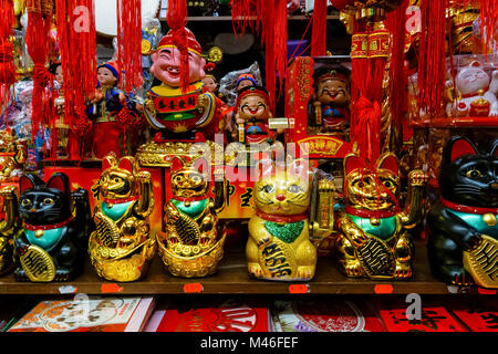 Lucky fortune cats, Maneki Neko, for sale in souvenir shop in Chinatown, London England United Kingdom UK Stock Photo
