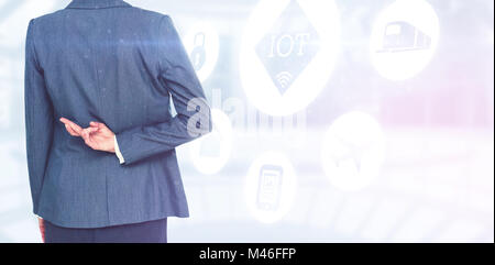 Composite image of businesswoman with fingers crossed behind her back Stock Photo