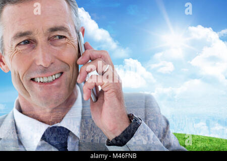 Composite image of buisnessman taking on mobile phone Stock Photo