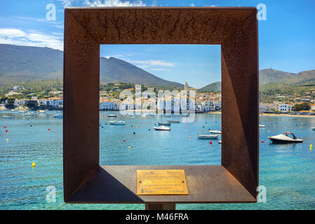 View of seaside Cadaques village through metal frame. In style of Dali artist's. Cadaques, Costa Brava, Catalonia, Spain Stock Photo