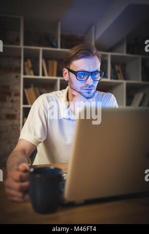 Young man working on laptop Stock Photo
