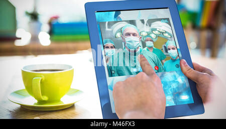 Composite image of smiling surgeon posing with a team Stock Photo