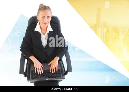 Composite image of businesswoman sitting on swivel chair with laptop Stock Photo