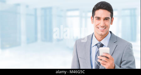 Composite image of businessman using mobile phone with colleagues behind Stock Photo