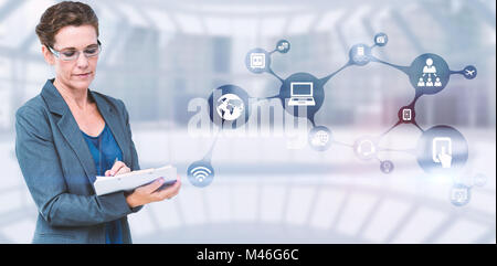 Composite image of businesswoman writing on clipboard Stock Photo