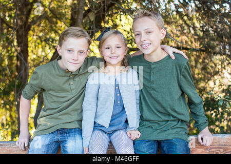 Happy brothers and sister playing at the park Stock Photo - Alamy
