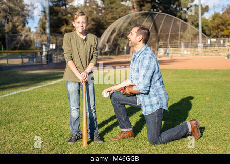 Father coach teaching son baseball Stock Photo