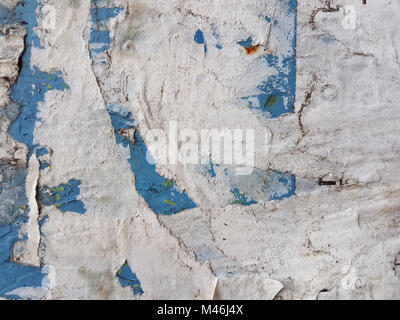 Crumpled white old paper, pasted on layers on a blue wall, trash texture. Stock Photo