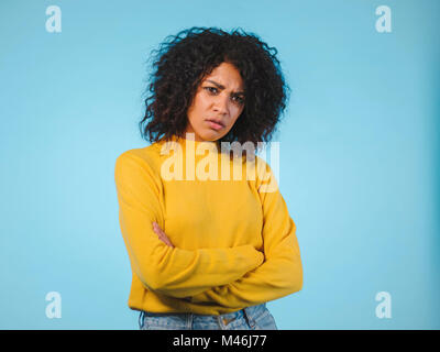 Angry annoyed young housewife keeping arms crossed and staring at camera with sceptical and distrustful look, feeling mad at someone. Human facial exp Stock Photo