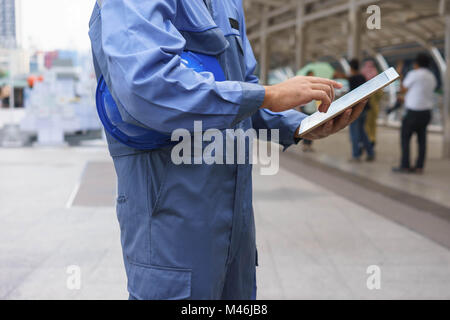 Mechanic is using tablet. Stock Photo