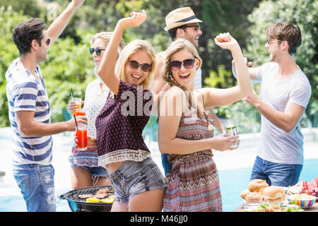 Group of friends dancing at outdoors barbecue party Stock Photo