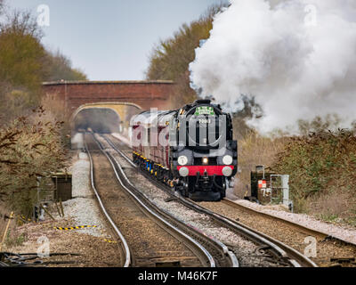The cathedrals express passes throuch Charing train station, Kentm UK pulled by the Oliver Cromwell locomotive 70013 Stock Photo