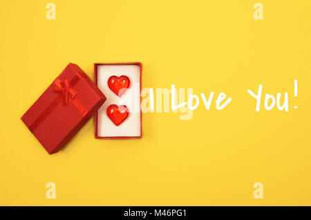 Red heart against yellow background. Stock Photo