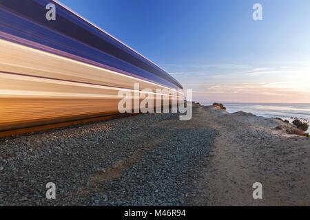 High Speed Blurred Bullet Coaster Commuter Train Motion, Del Mar Heights. Pacific Ocean Rail Line Southern California Coastline San Diego County USA Stock Photo