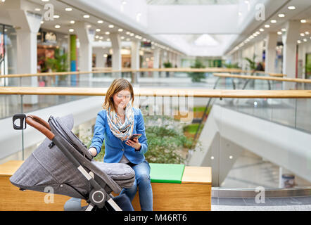 Young woman reading on mobile phone Stock Photo