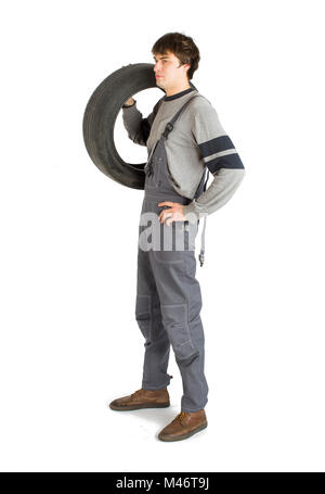 A young brunet foreman in working grey uniform with black wheel. Stock Photo