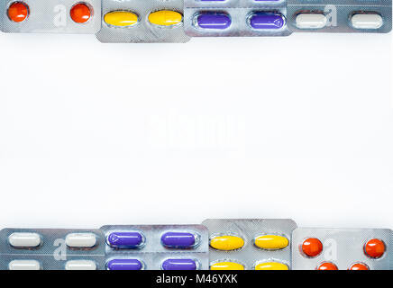 Tablets pills medicine in blister pack with frame pattern and space box for text. Colorful tablets pills with creative pattern on white background. Ba Stock Photo