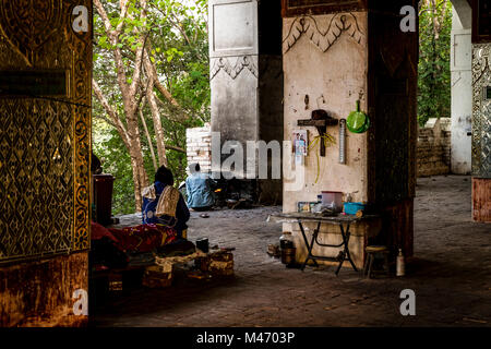 Men waking at sunrise in temple on Mandalay Hill Myanmar Stock Photo