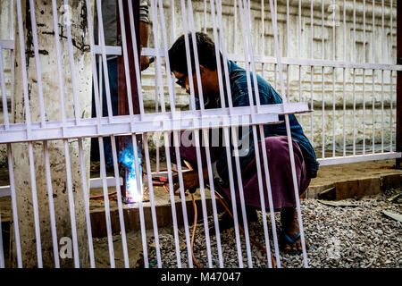 Man welding on the streets of Mandalay Stock Photo