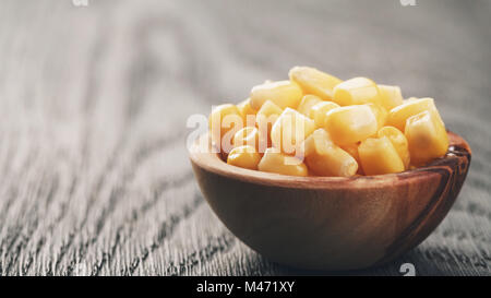 sweet canned corn in wood bowl on wood table Stock Photo