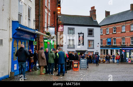 Ashbourne, UK. 14th Febraury, 2018. Celebrations, beer, fish & chips at the end of the wet two day Ashbourne Royal Shrovetide hugball Football match Shrove Ash Wednesday 14th February 2018. Ye Olde & Ancient Medieval hugball game is the forerunner to football. It's played between two teams, the Up'Ards & Down'Ards separated by the Henmore Brook river. The goals are 3 miles apart at Sturston Mill & Clifton Mill. Credit: Doug Blane/Alamy Live News Stock Photo