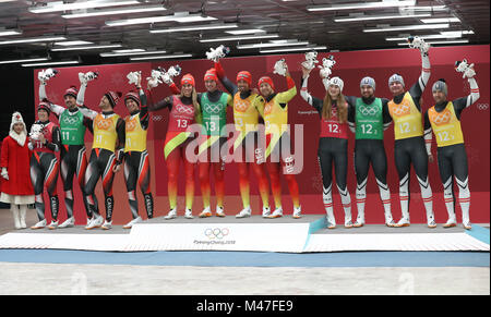 (180215) -- PYEONGCHANG, Feb. 15, 2018 (Xinhua) -- Members of champion team Germany (C),second-placed Canada (L) and third-placed Austria pose for photos during venue ceremony of team relay competition of luge at 2018 PyeongChang Winter Olympic Games at Olympic Sliding Centre, PyeongChang, South Korea. (Xinhua/Li Gang) Stock Photo