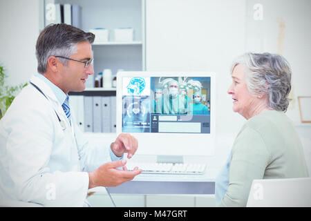 Composite image of smiling surgeon posing with a team Stock Photo