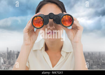 Composite image of closeup of a businesswoman looking through binoculars Stock Photo