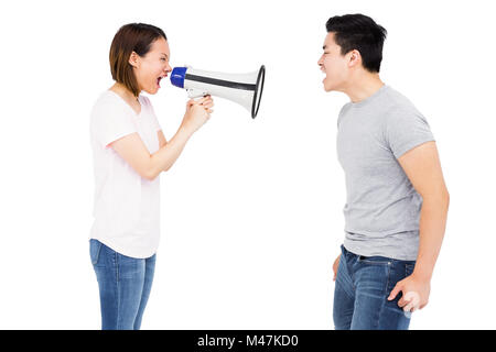 Angry woman shouting at young man on horn loudspeaker Stock Photo