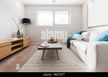 Scandi style living room interior with teal accent cushions Stock Photo