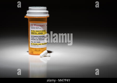 Hydrocodone Pills and Prescription Bottle with Non Proprietary Label. No model release required - contains ficticious information. Stock Photo