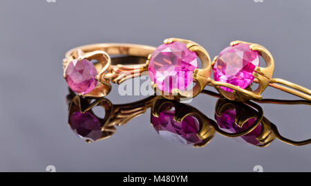 Set gold jewelry from rings and earrings with alexandrite Stock Photo